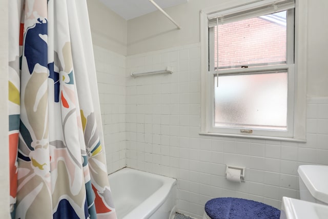 bathroom featuring shower / tub combo with curtain and tile walls