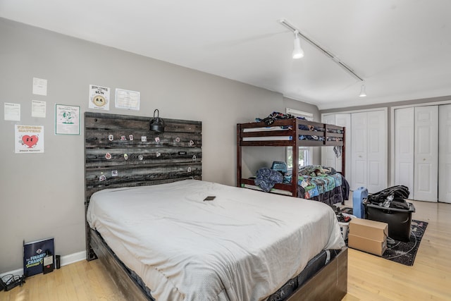 bedroom featuring light wood-type flooring and rail lighting