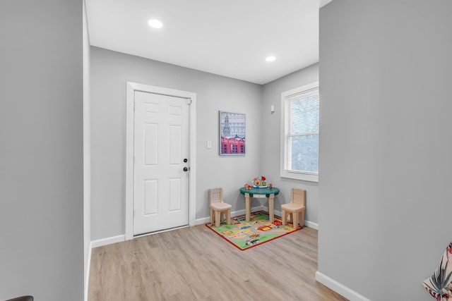 game room with light hardwood / wood-style floors