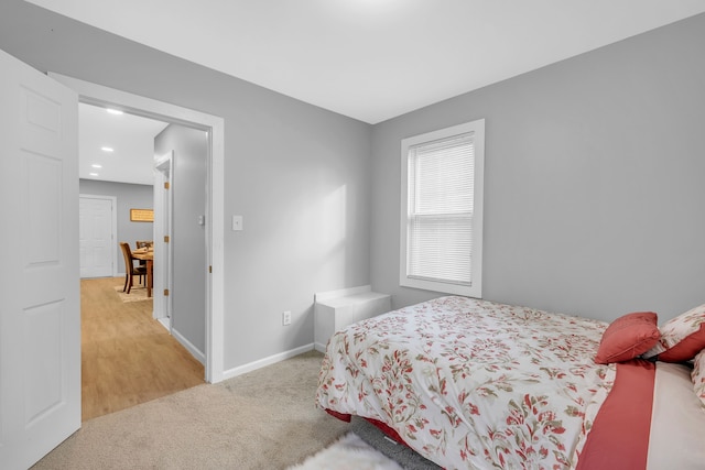 bedroom featuring light colored carpet