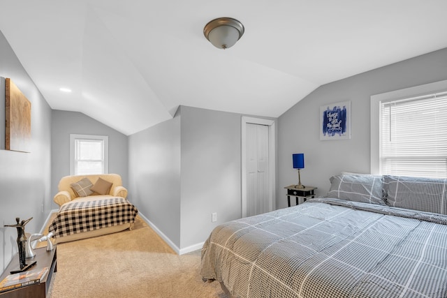 bedroom with a closet, carpet floors, and vaulted ceiling