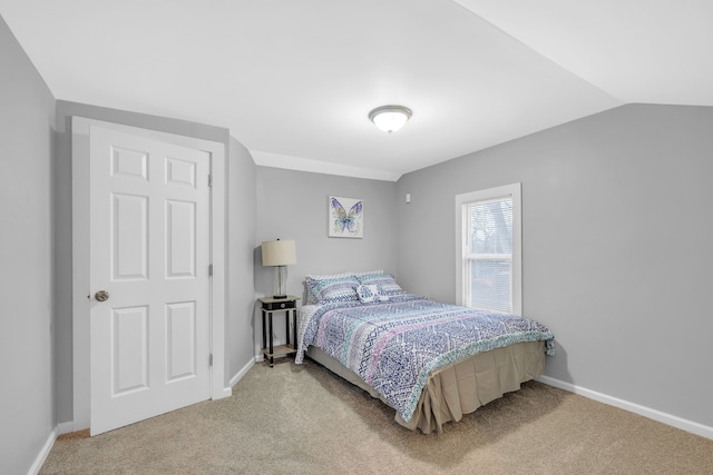 bedroom with carpet and lofted ceiling