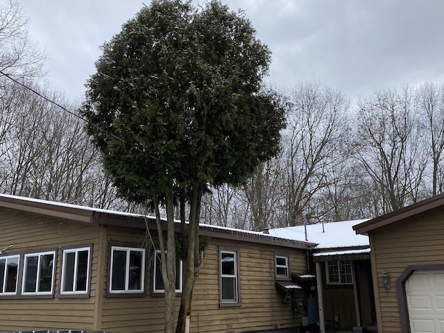 view of side of home featuring a garage