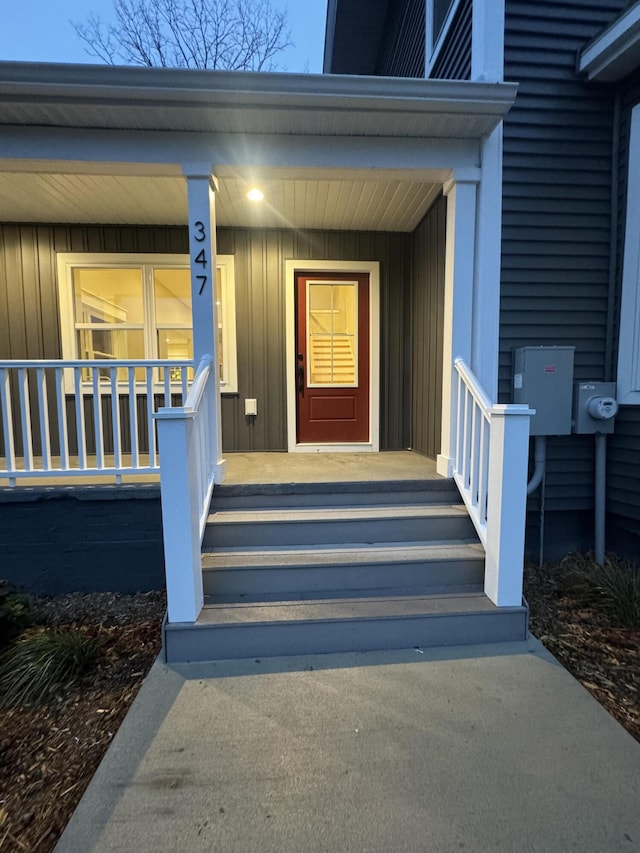 view of exterior entry with a porch