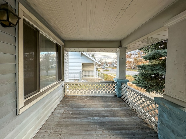 wooden terrace featuring covered porch