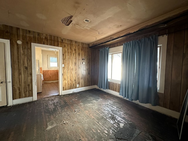 miscellaneous room with wood walls and dark wood-type flooring