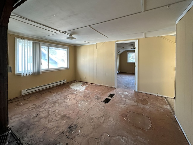 empty room featuring a healthy amount of sunlight, ceiling fan, and a baseboard radiator