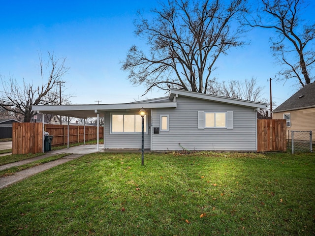 back of property featuring a carport and a yard