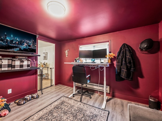 office area with hardwood / wood-style flooring and a baseboard radiator