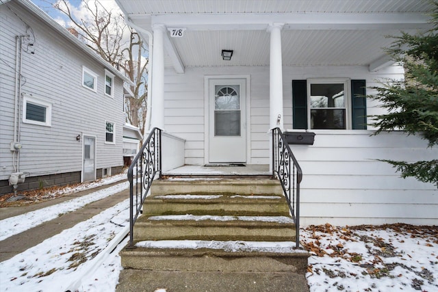 view of snow covered property entrance