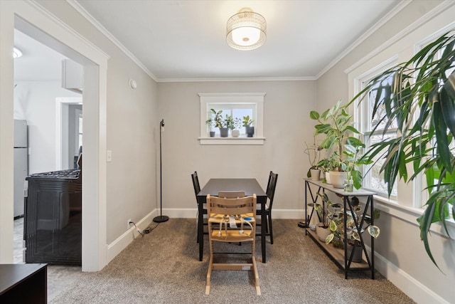 dining room with light colored carpet and ornamental molding