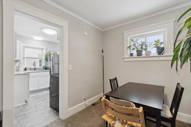 dining area with ornamental molding and sink