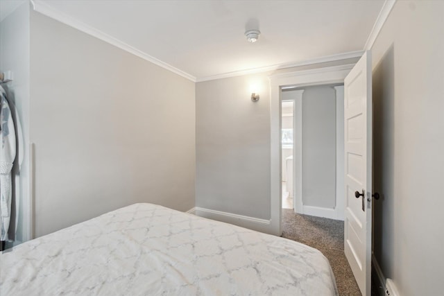 carpeted bedroom with a baseboard radiator and ornamental molding