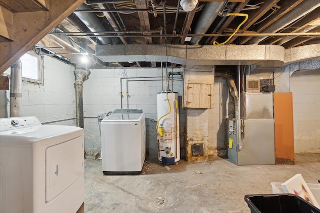 basement with heating unit, washer and clothes dryer, and gas water heater