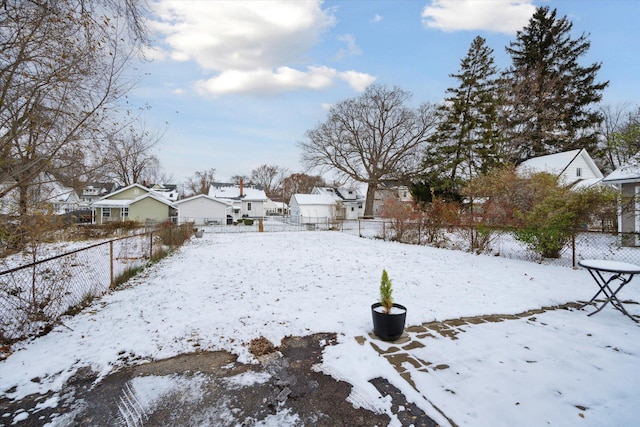 view of yard layered in snow