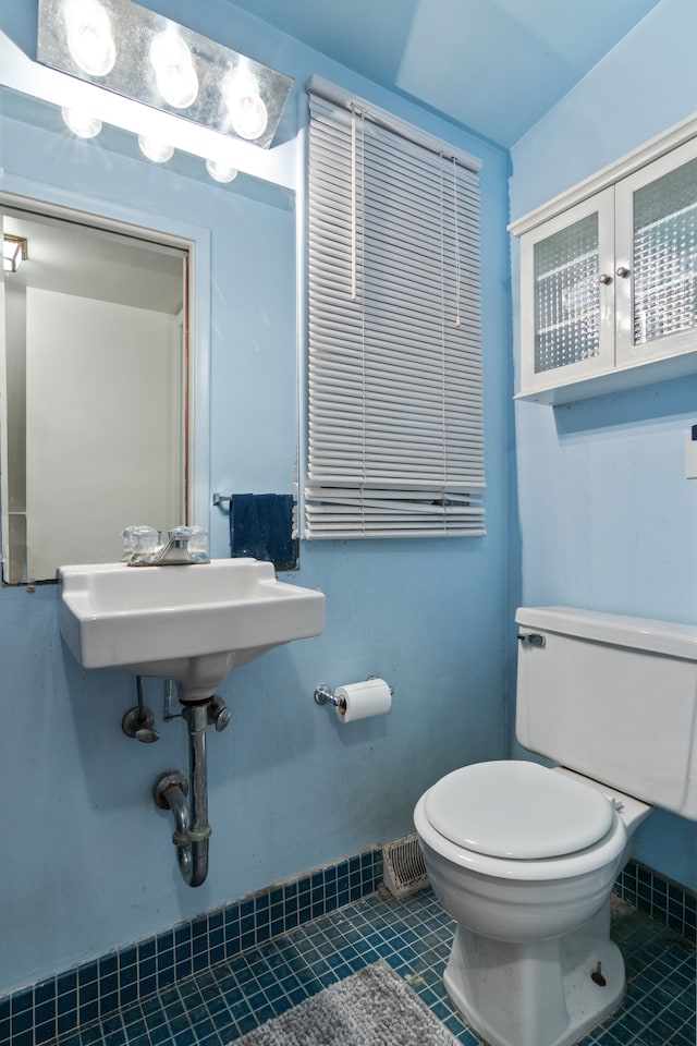 bathroom with tile patterned floors and toilet