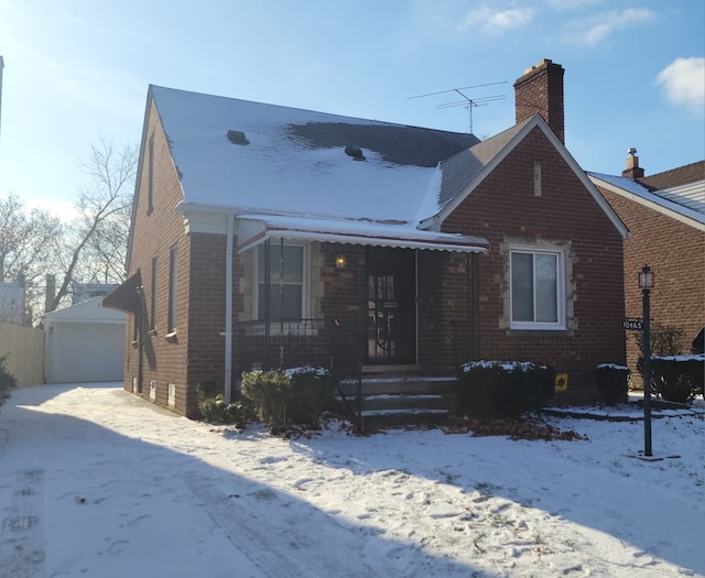 view of front of home with an outbuilding, a porch, and a garage