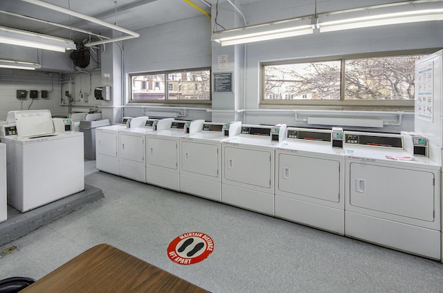 washroom featuring plenty of natural light and washing machine and clothes dryer