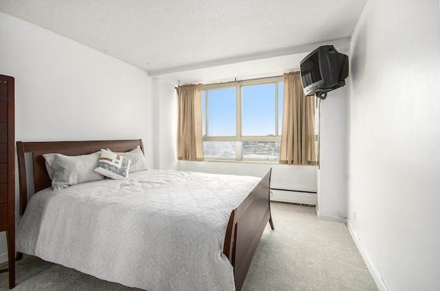 bedroom featuring a textured ceiling, carpet floors, and baseboard heating