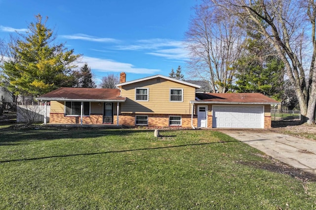 tri-level home featuring a garage and a front yard