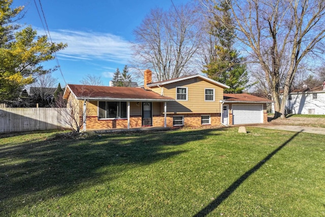 tri-level home featuring a front yard and a garage