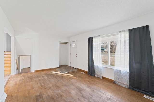 6058 Meadowwood Ln, Grand Blanc, MI 48439 - unfurnished room with hardwood / wood-style floors and a textured ceiling