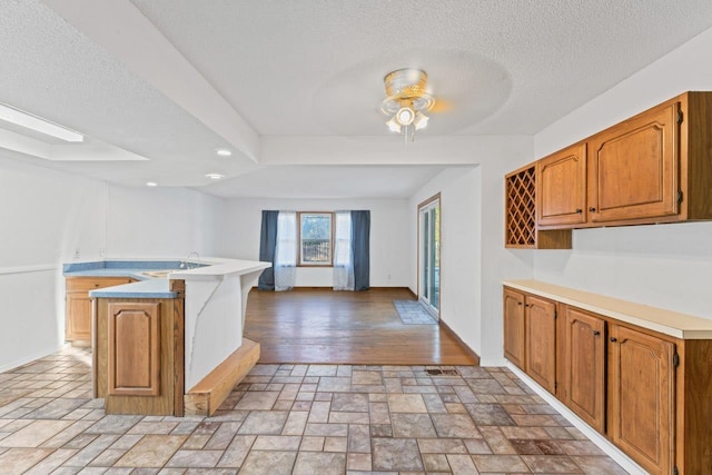 6058 Meadowwood Ln, Grand Blanc, MI 48439 - kitchen featuring a textured ceiling, ceiling fan, light wood-type flooring, and sink