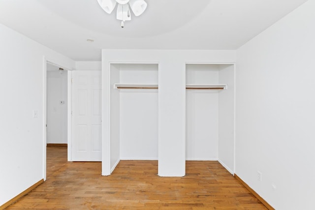 6058 Meadowwood Ln, Grand Blanc, MI 48439 - unfurnished bedroom featuring multiple closets and light hardwood / wood-style flooring