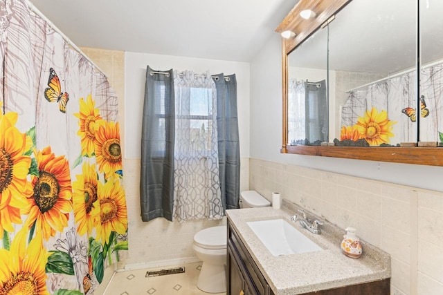 6058 Meadowwood Ln, Grand Blanc, MI 48439 - bathroom with tile patterned floors, vanity, tile walls, and toilet