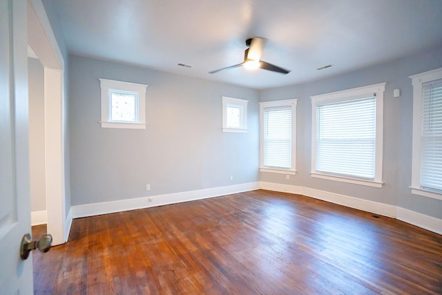 spare room featuring ceiling fan and dark wood-type flooring