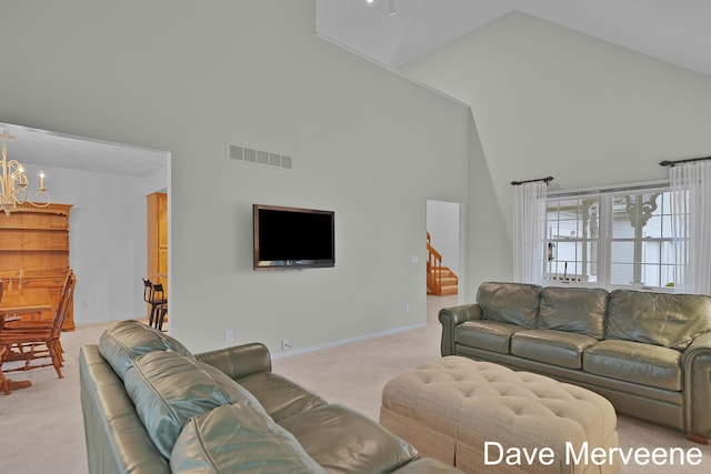 carpeted living room with high vaulted ceiling