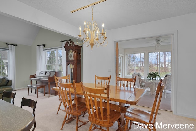 dining area with a textured ceiling, light carpet, ceiling fan with notable chandelier, and vaulted ceiling