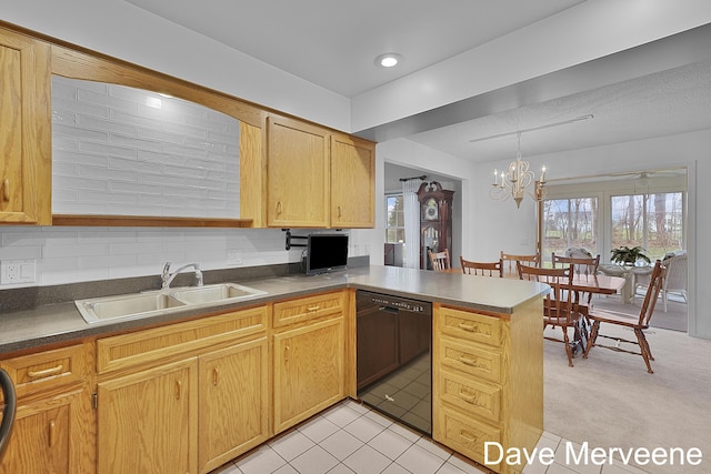 kitchen with kitchen peninsula, sink, decorative light fixtures, a notable chandelier, and black dishwasher