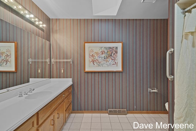 bathroom with tile patterned floors, vanity, and toilet