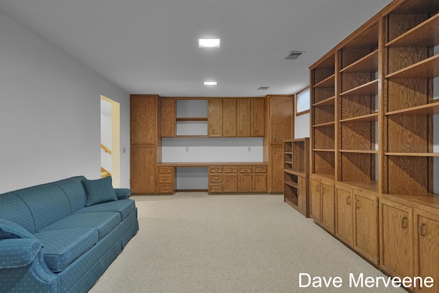 carpeted living room with built in desk