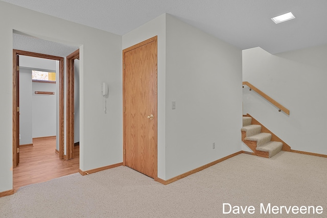 interior space featuring carpet and a textured ceiling