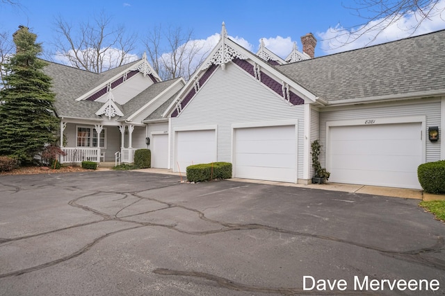 view of front of property featuring a porch and a garage