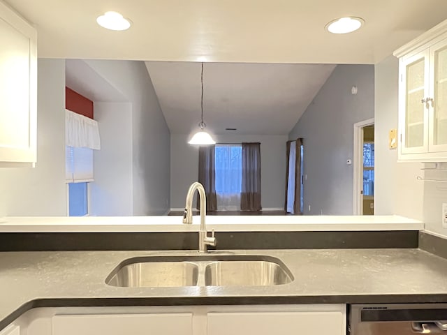 kitchen featuring pendant lighting, sink, stainless steel dishwasher, and white cabinets