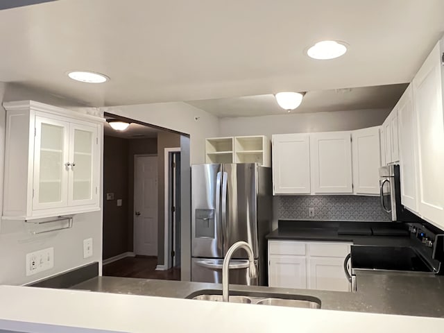 kitchen with sink, decorative backsplash, white cabinets, and appliances with stainless steel finishes