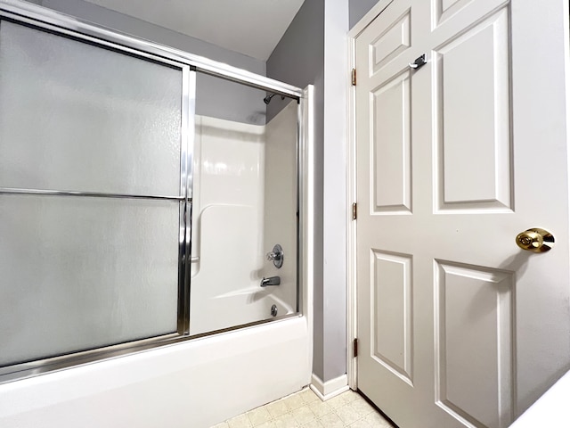 bathroom featuring combined bath / shower with glass door