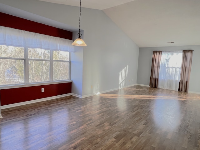 interior space featuring lofted ceiling and dark wood-type flooring