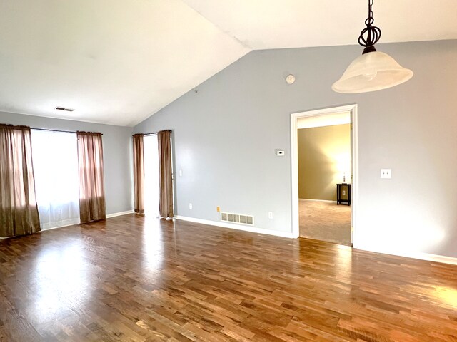 empty room featuring hardwood / wood-style flooring and lofted ceiling