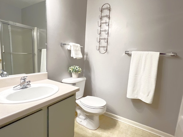 bathroom featuring an enclosed shower, vanity, and toilet