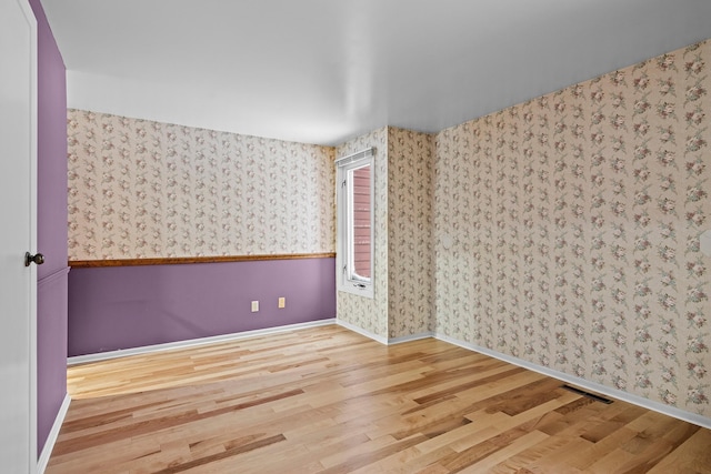 spare room with hardwood / wood-style flooring