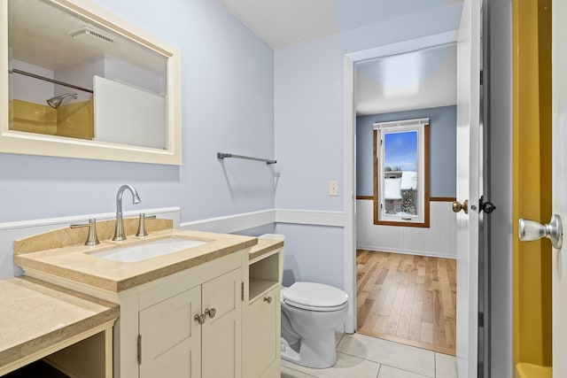 bathroom with hardwood / wood-style floors, vanity, and toilet