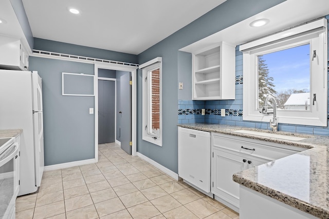 4243C Summerhill Rd, Traverse City, MI 49684 - kitchen featuring white appliances, white cabinets, tasteful backsplash, open shelves, and light stone countertops