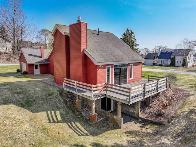 4243C Summerhill Rd, Traverse City, MI 49684 - rear view of property with a deck, a yard, a chimney, and a shingled roof