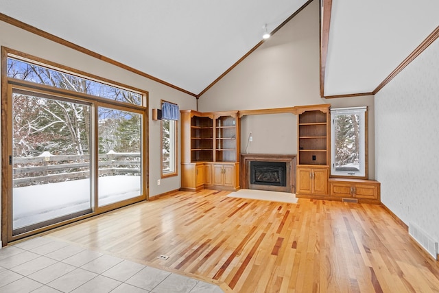 4243C Summerhill Rd, Traverse City, MI 49684 - unfurnished living room with light wood-style floors, a fireplace, wallpapered walls, high vaulted ceiling, and ornamental molding