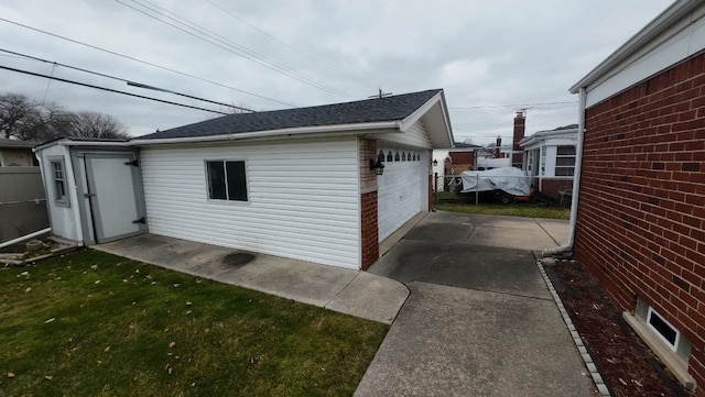 view of property exterior with a garage, an outdoor structure, and a yard