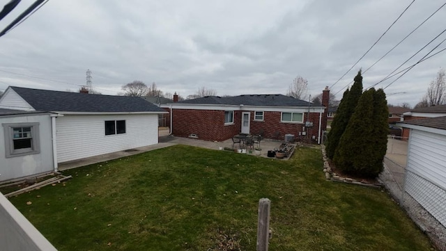 rear view of property with a patio area and a yard